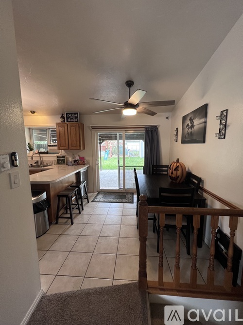 A kitchen with a dining table and chairs.