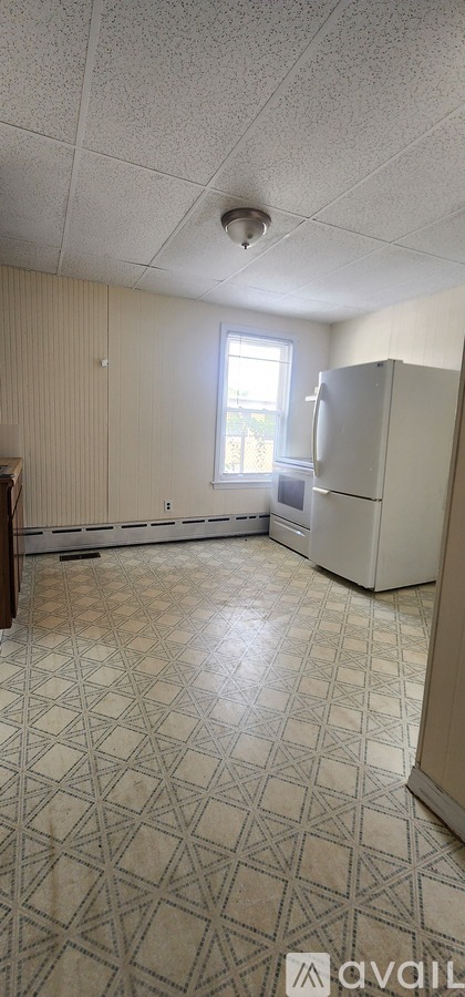 A room with a tiled floor and a window.