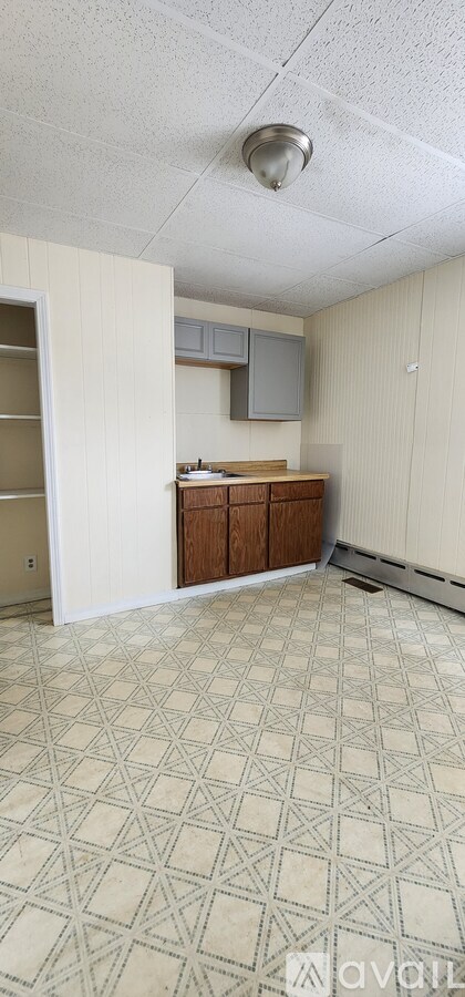 A room with a tile floor and a ceiling light.