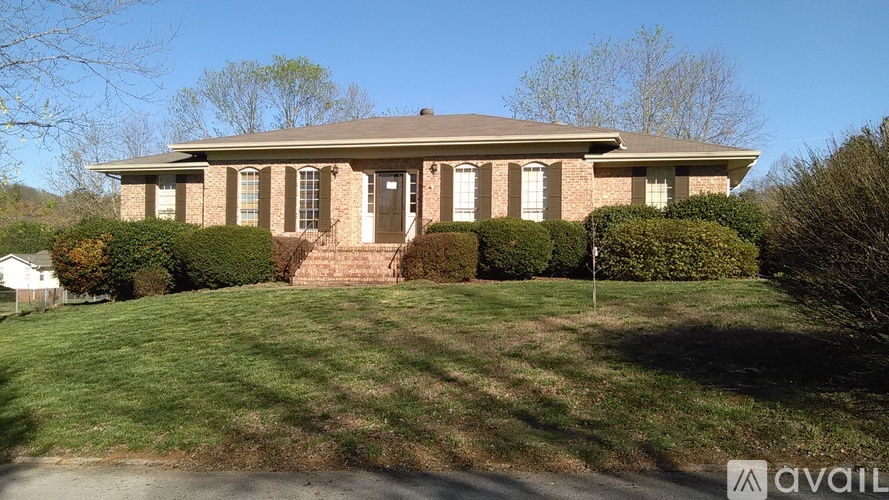 A house with a lawn in front of it.