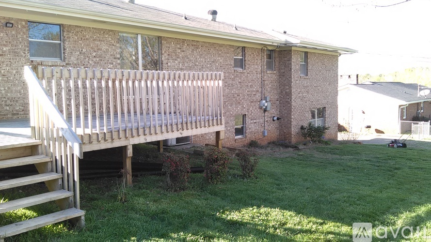 A house with a wooden deck in front.