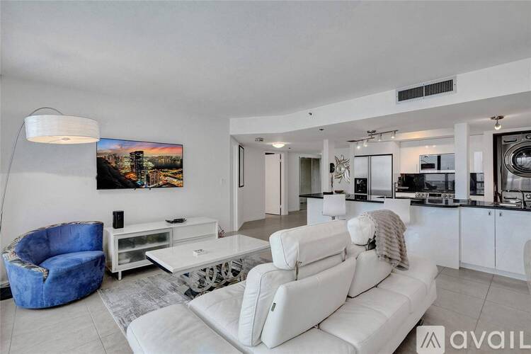 A modern living room with a blue armchair and a white sofa.