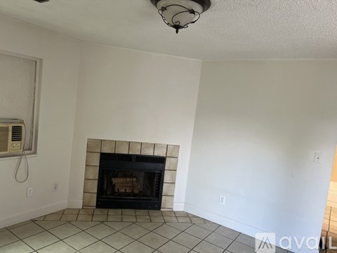 A white door is open to a room with a tiled floor.