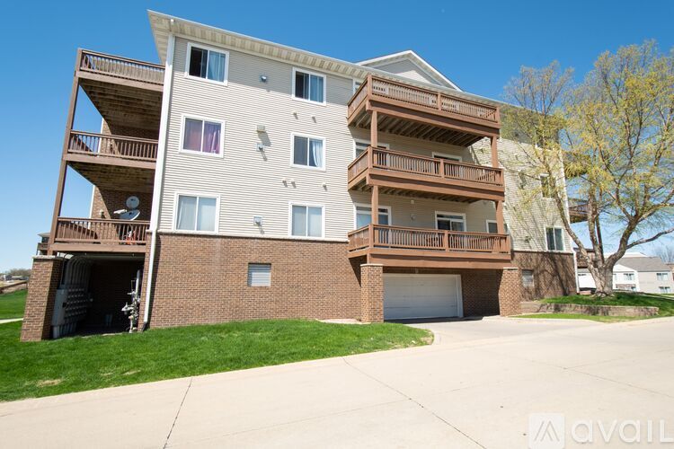 A large apartment building with multiple balconies and a garage door.