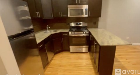 A kitchen with wooden floors and a countertop.