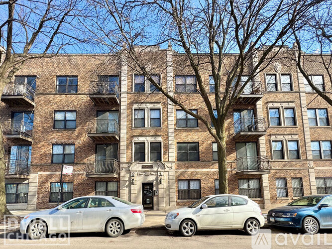 A row of cars parked in front of a building.