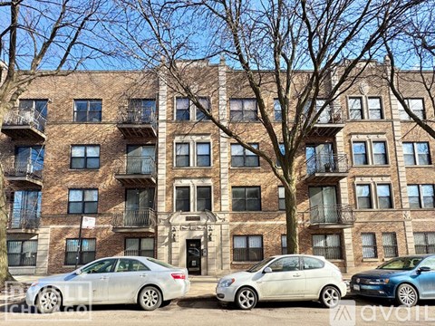 A row of cars parked in front of a building.