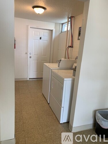 A bathroom with a white door and a white cabinet.