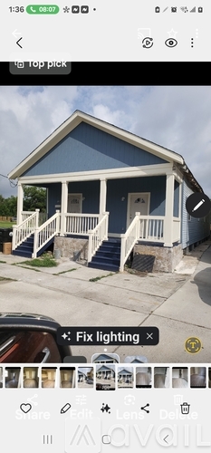 A blue house with white trim and a porch.