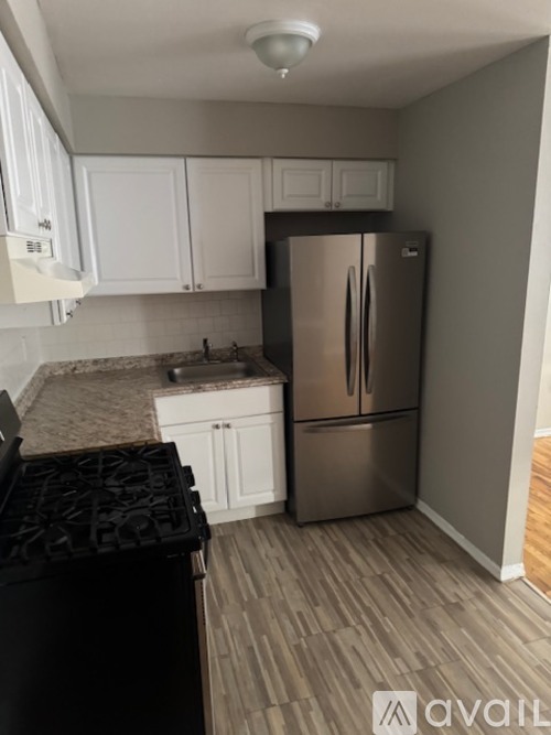 A kitchen with a table and chairs in the middle of it.