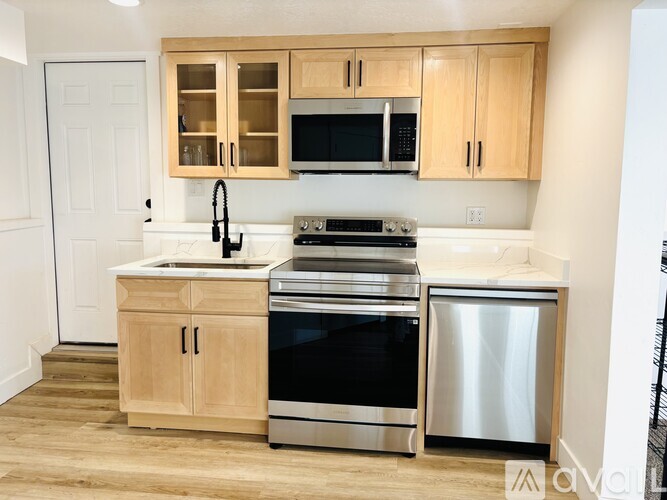 A kitchen with wooden cabinets and stainless steel appliances.