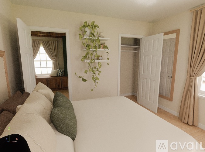 A living room with a white couch and a green plant on the wall.