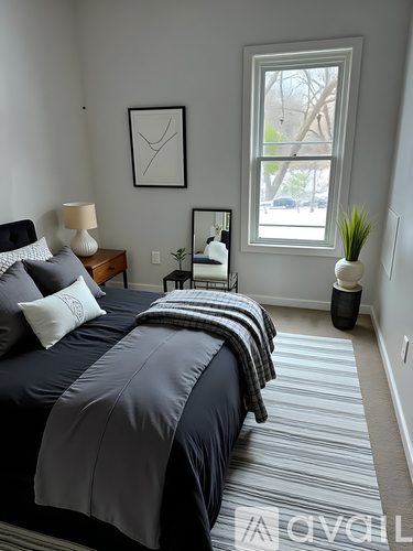 A bedroom with a large bed and a window.