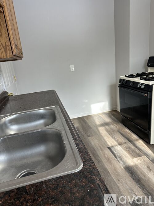 A kitchen with a stove and a sink.