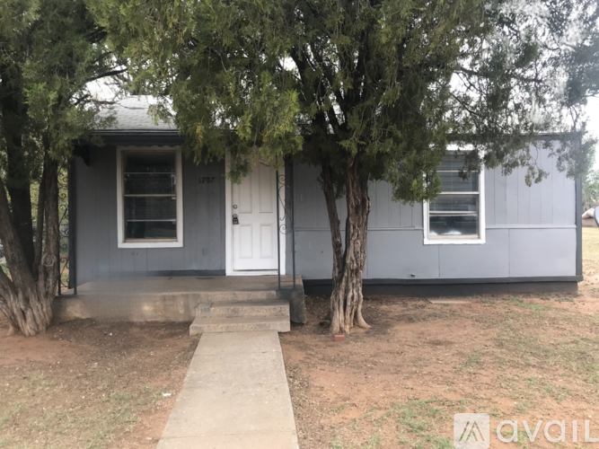 A house with a "For Lease" sign in front of it.