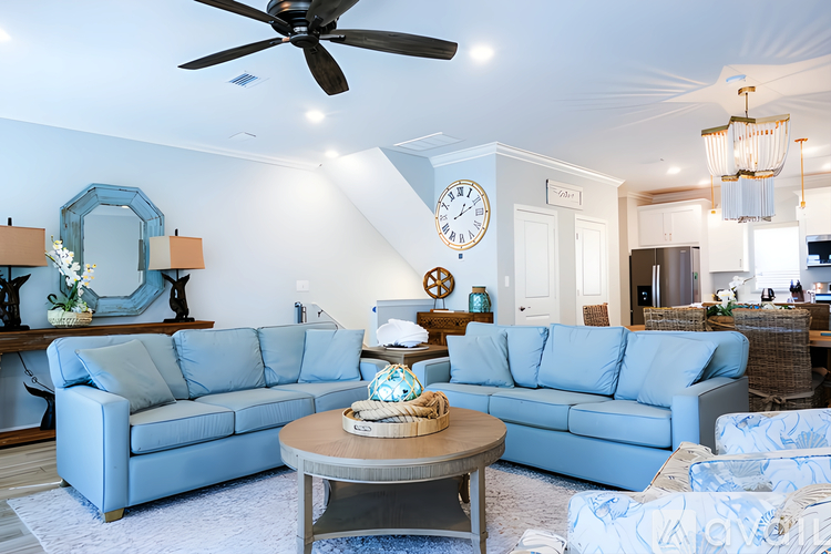 A living room with a blue couch and a coffee table.