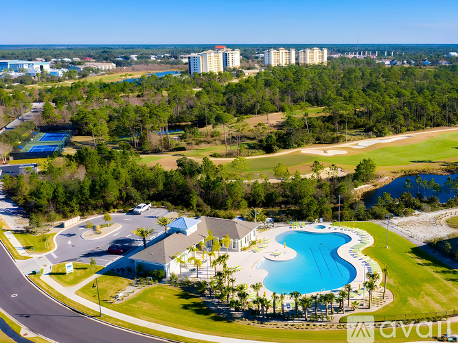 A bird's eye view of a resort with a swimming pool and a road.