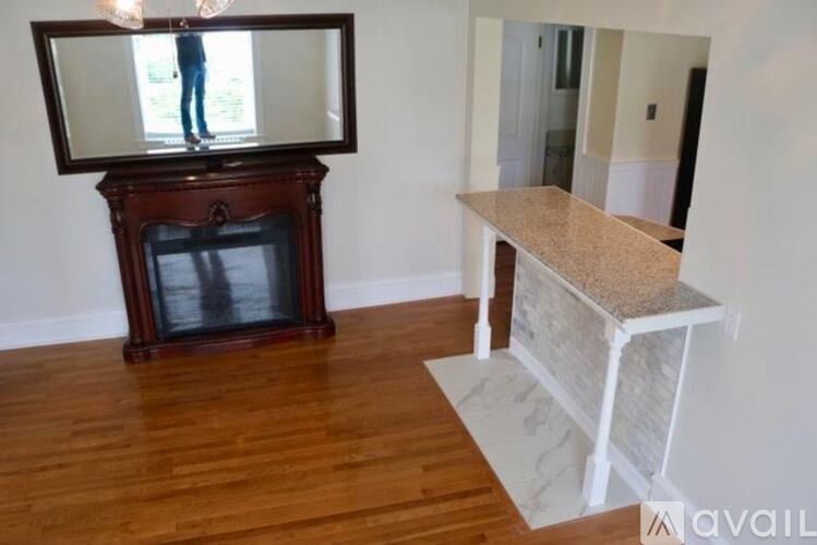 A living room with a television and a marble table.