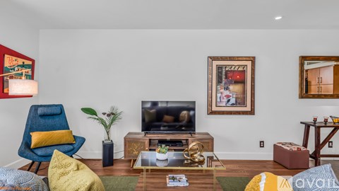 A living room with a blue chair and a yellow pillow.