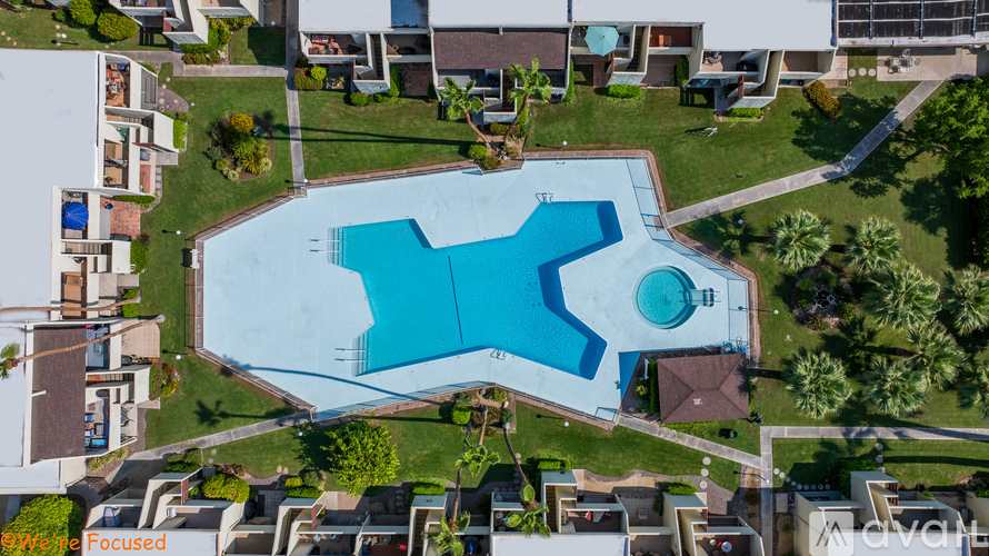 A swimming pool surrounded by houses.