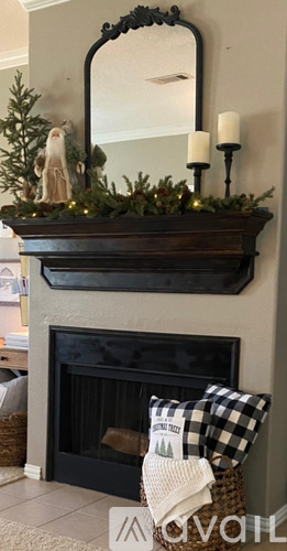 A mantle with a mirror and a candle holder.