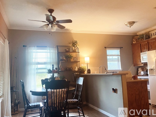 A kitchen with a dining table and chairs.