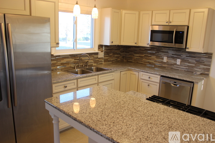 A kitchen with granite countertops and stainless steel appliances.