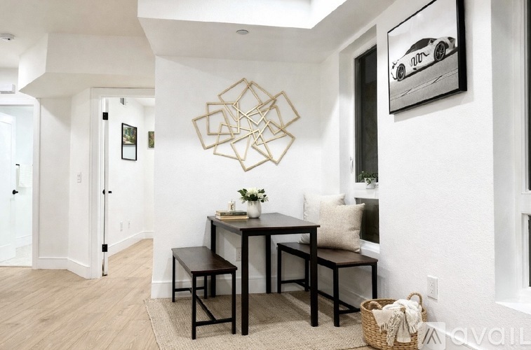 A dining area with a table and chairs.