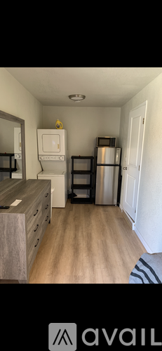 A kitchen with a white fridge and a microwave above it.