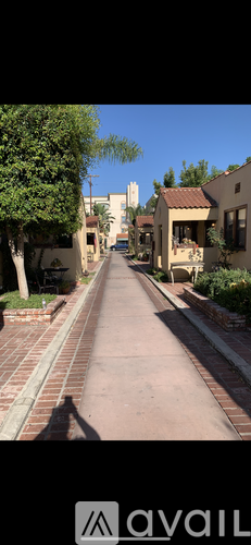 A long, narrow street with a sidewalk on both sides.