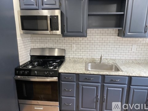 A kitchen with wooden floors and stainless steel appliances.