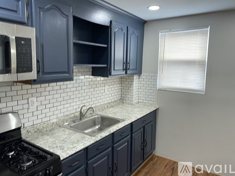 A small white bathroom with a toilet, sink, and light fixture.