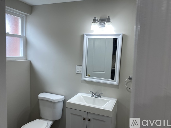 A room with wooden floors and white walls.