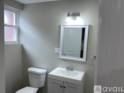 A room with wooden floors and white walls.