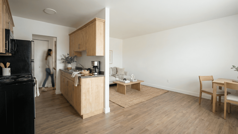 A kitchen with wooden floors and furniture.