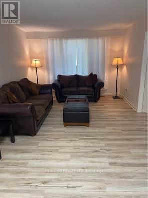 A living room with two couches and two lamps.