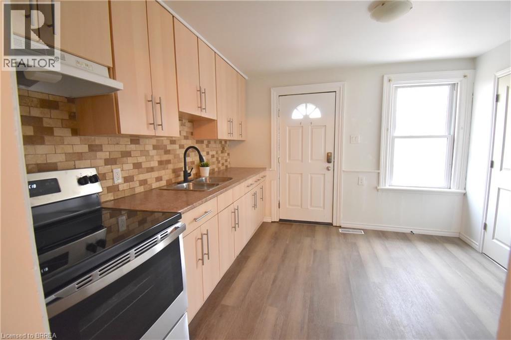 A kitchen with wooden cabinets and a black stove top oven.