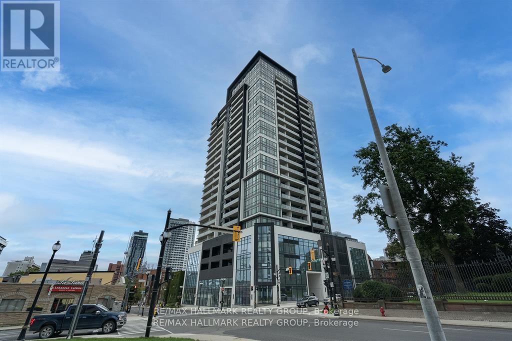 A tall building with a glass facade is the main focus of the image.