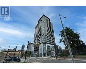 A tall building with a glass facade is the main focus of the image.