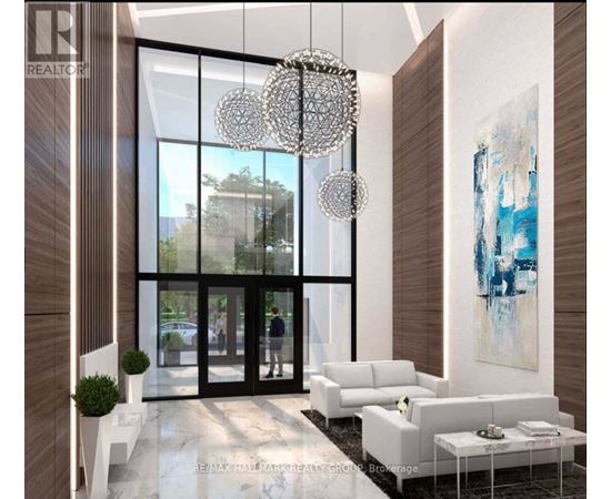 A modern living room with a large chandelier and a painting on the wall.