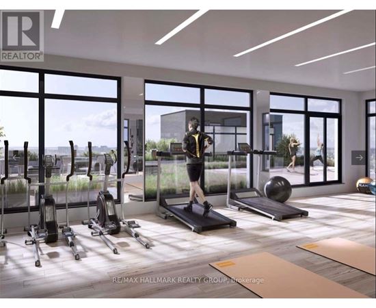 A woman is working out on a treadmill in a spacious gym with various exercise equipment.