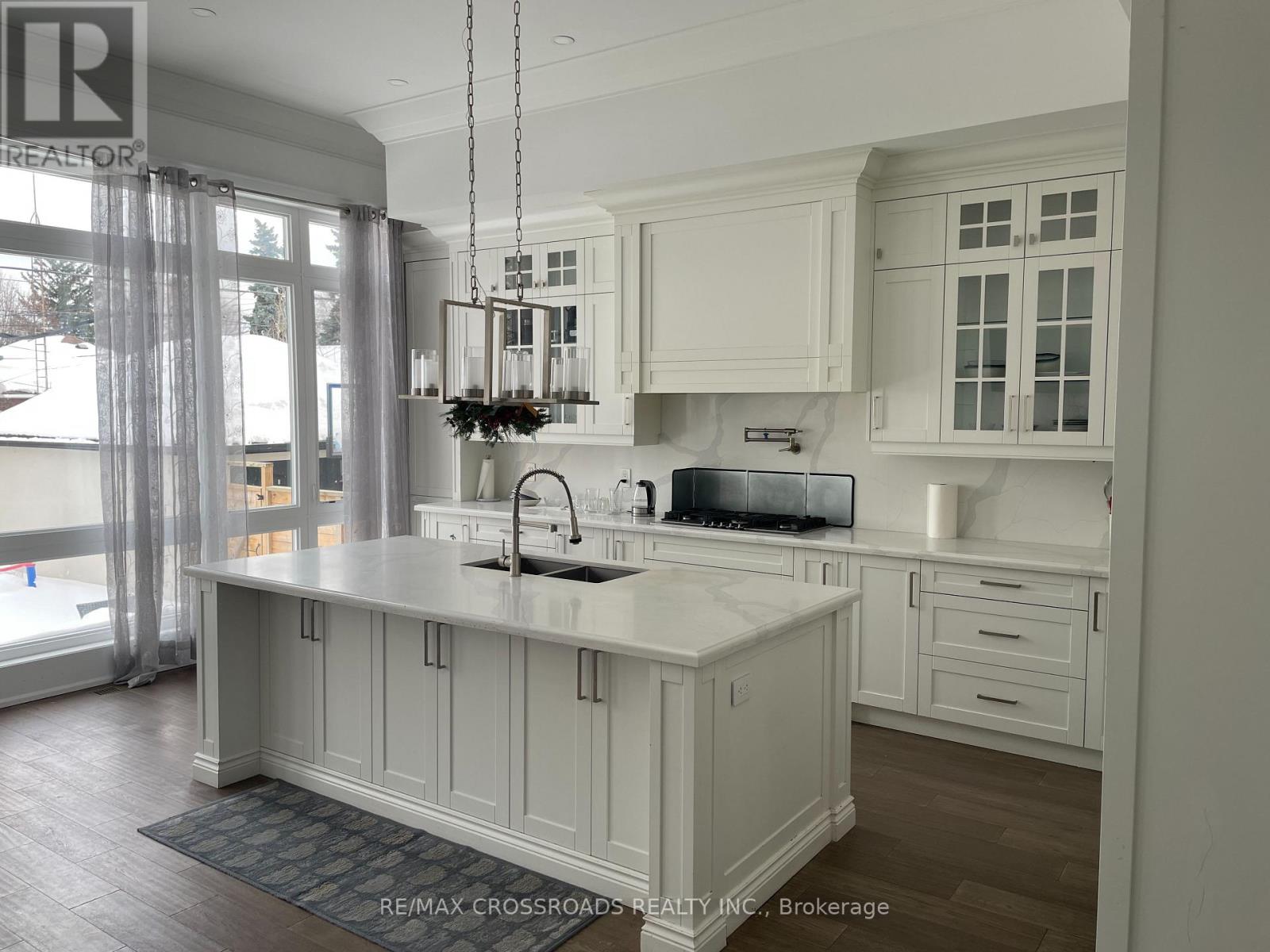 A kitchen with white cabinets and a large island.