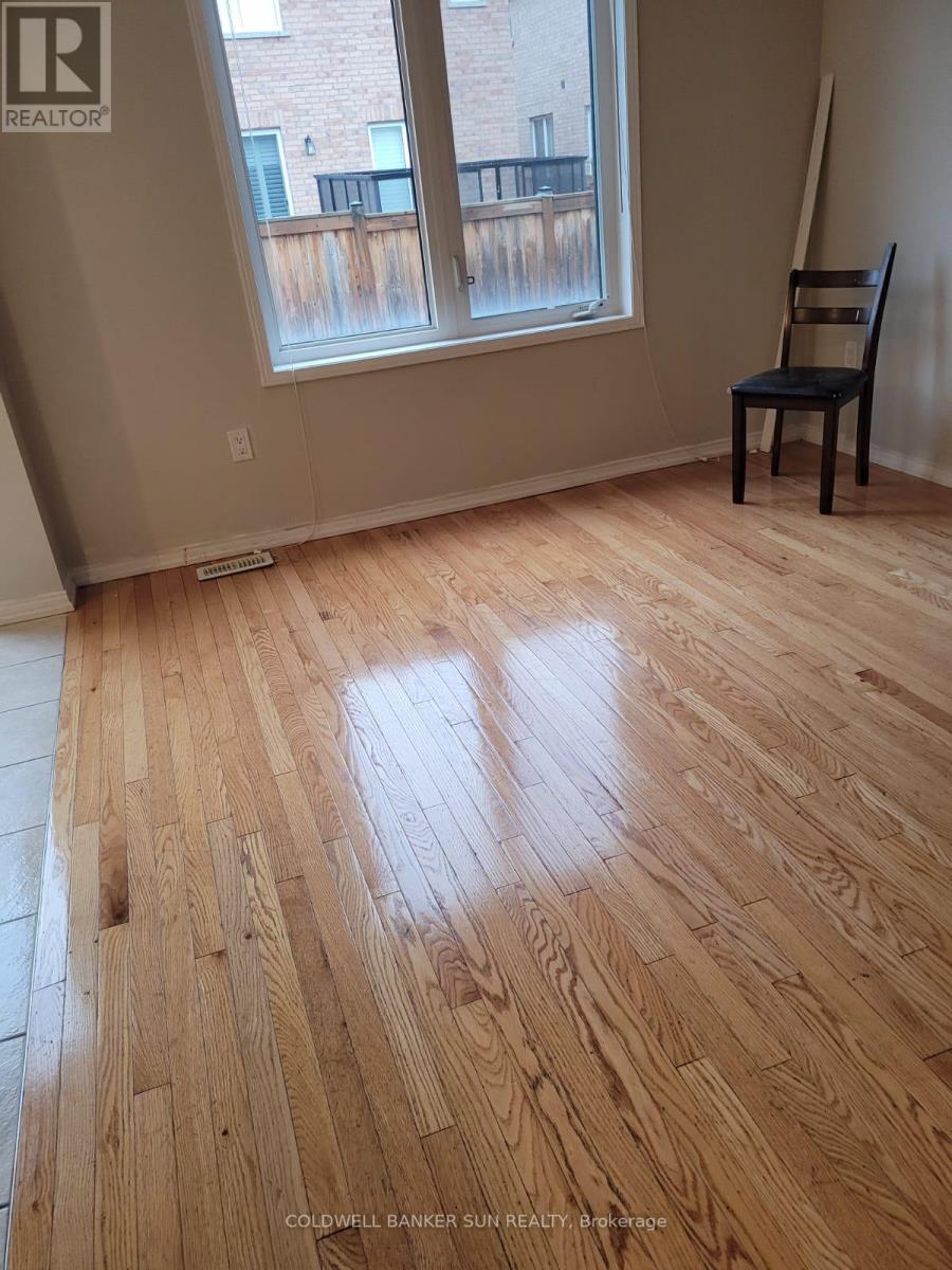 A room with wooden flooring and a chair.