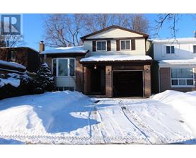 A house with a snow-covered driveway in front.