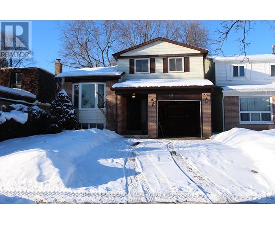 A house with a snow-covered driveway in front.