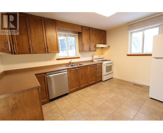 A kitchen with wooden cabinets and a white refrigerator.