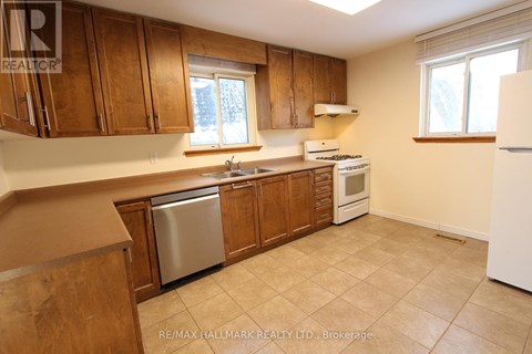 A kitchen with wooden cabinets and a white refrigerator.