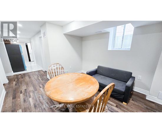 A dining room with a wooden table and chairs.