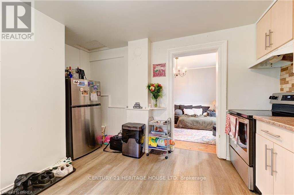A kitchen with a refrigerator, a microwave, and a dishwasher.