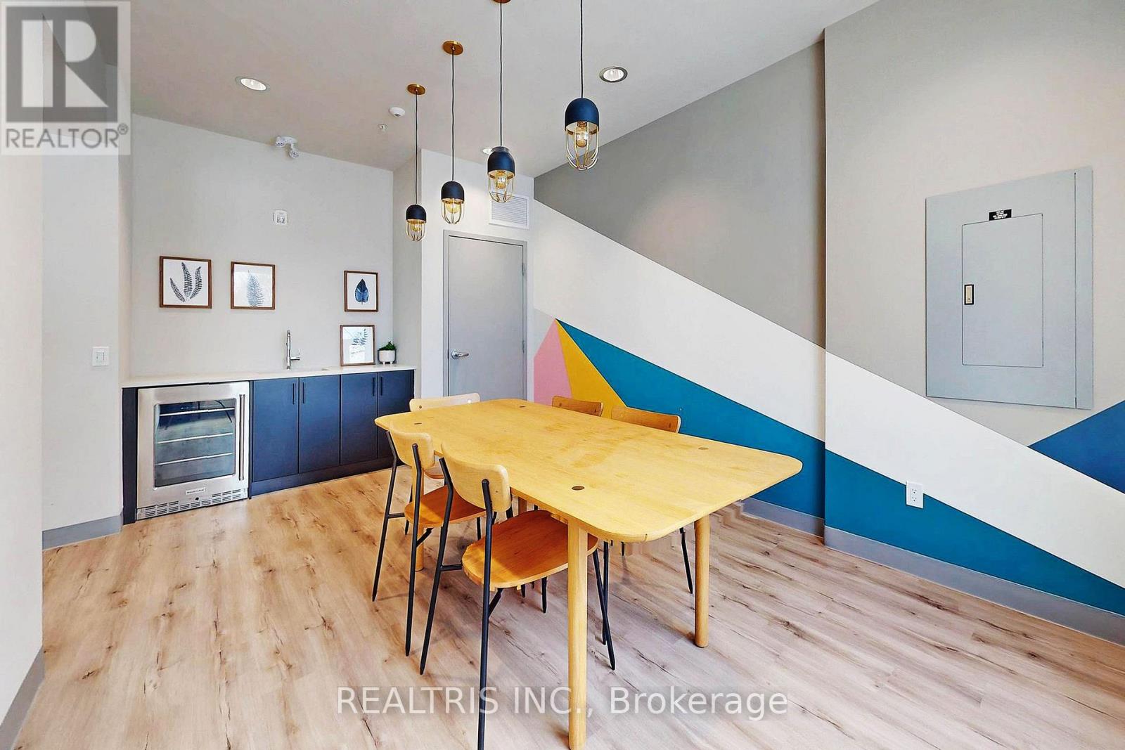 A dining room with a wooden table and chairs.